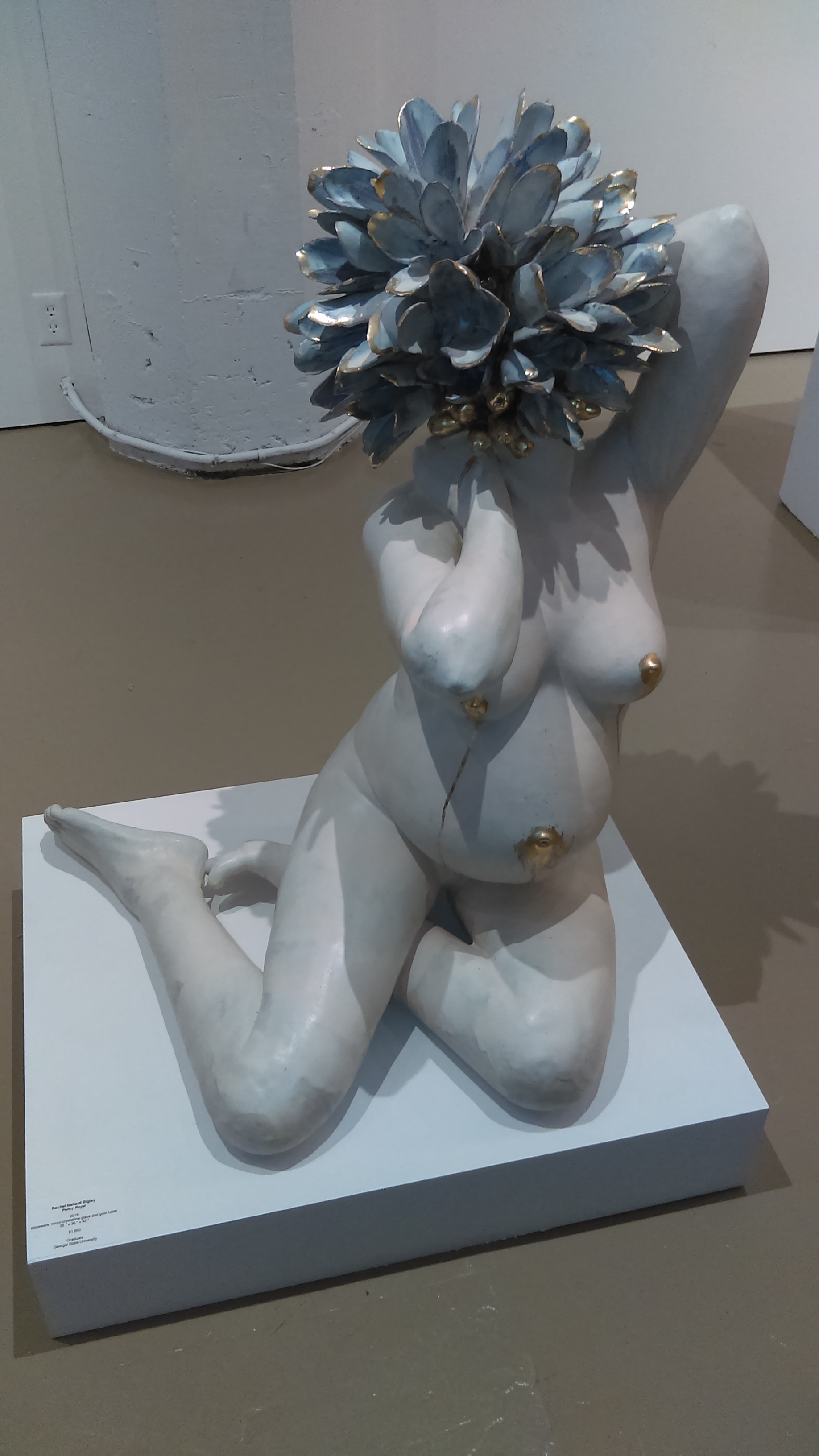 Penny Royal Rachel Ballard Bigley , 2015 (stoneware, micro-crystalline glaze, gold luster). At first glance she might be wearing a hat, but really, the flower is her head. It’s unsettling, absurd and enchanting. As though she needs to show you something, but can’t say what.