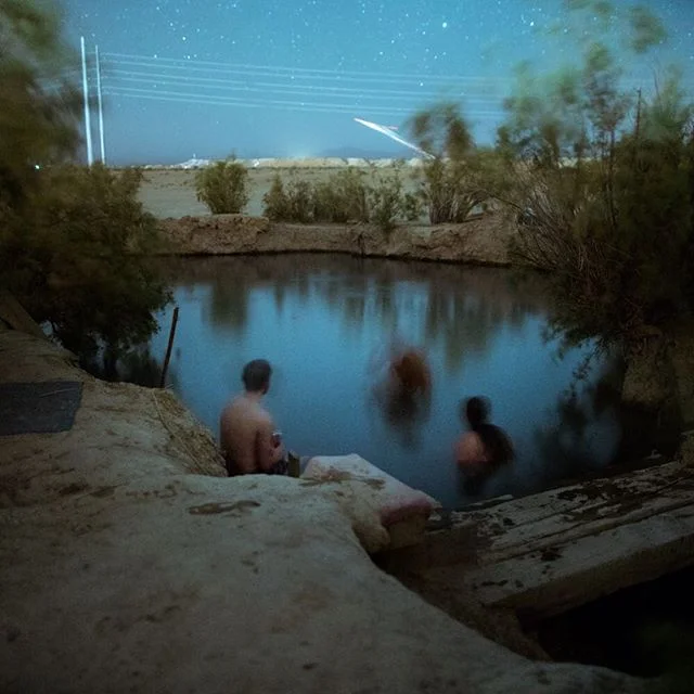 Slab City XIX // a midnight dip in the hot springs, illuminated by tracers from a nearby fire fight. The Sonoran is still used by the military to train personnel and develop and test equipment for desert combat.