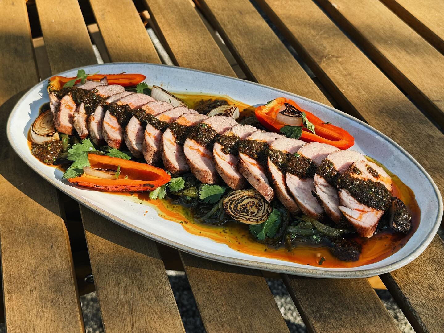 New to our Protein Board Spring Menu- GRILLED PORK TENDERLOIN with Poblano Piperade, Red Chimichurri, Grilled Peppers, and Spring Onions ✨ #homespunatl