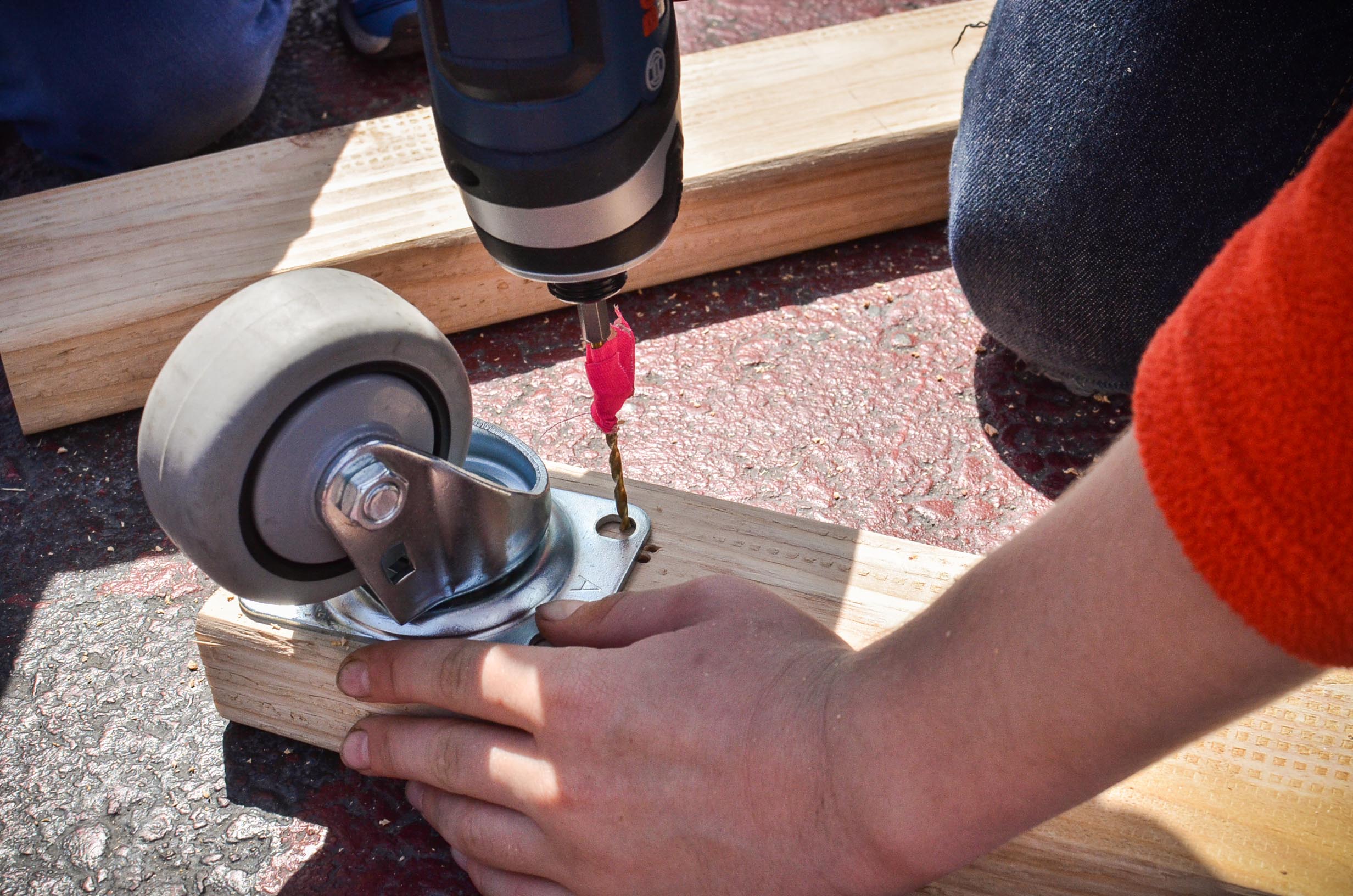 They cleverly use pink tape as a depth setter so they don't drill through the wood and into the ground below.