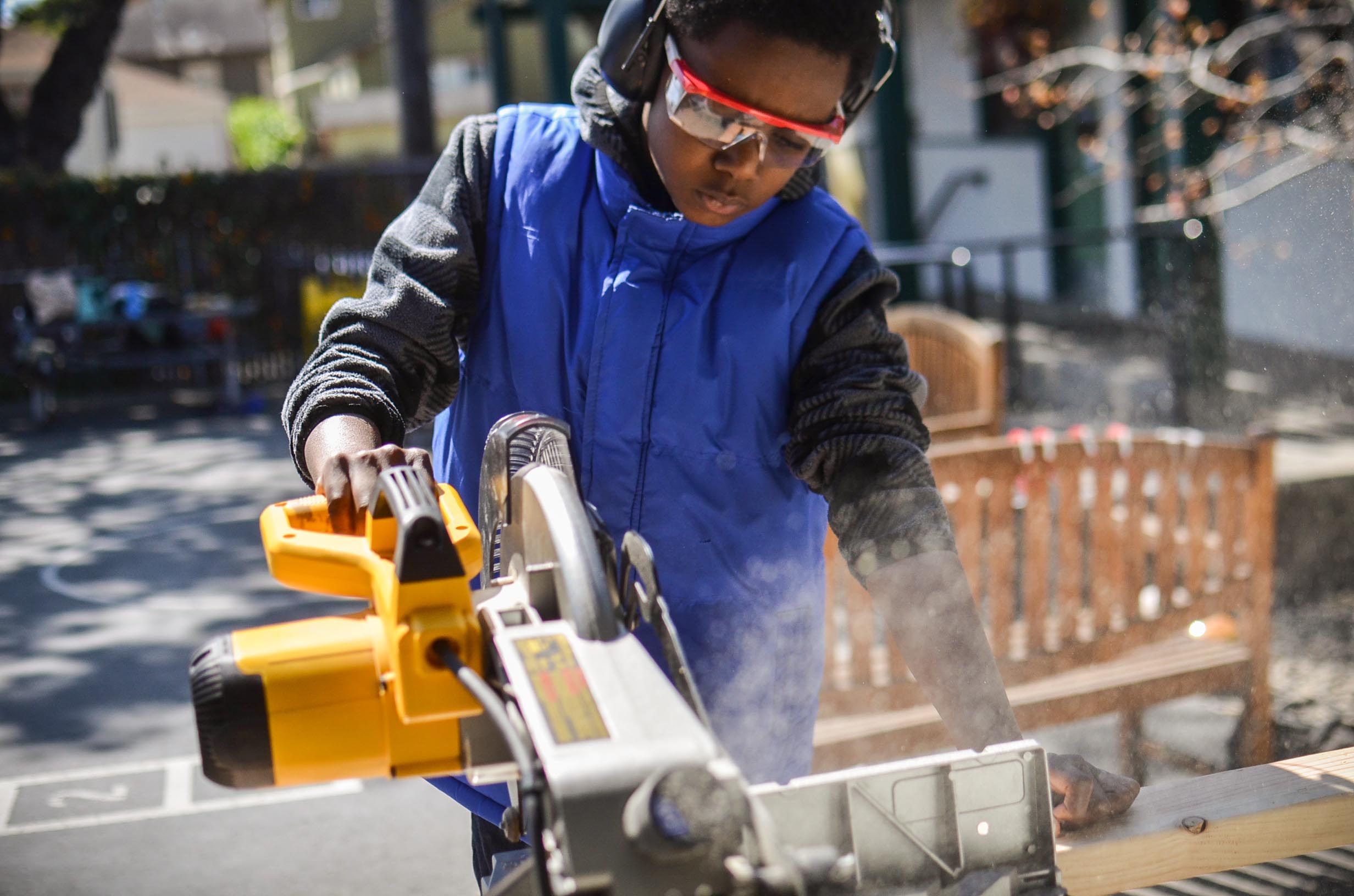 Taj makes another controlled and precise cut on the chop saw.