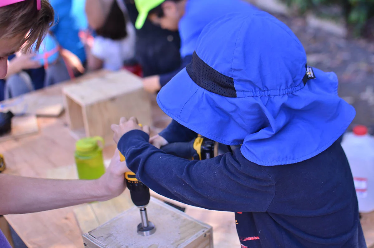 Logan works on a water release contraption. 