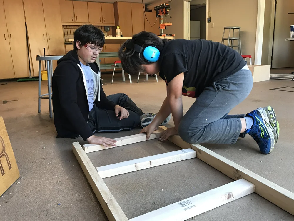  Sebastien and Victor piece together their cart's frame. 