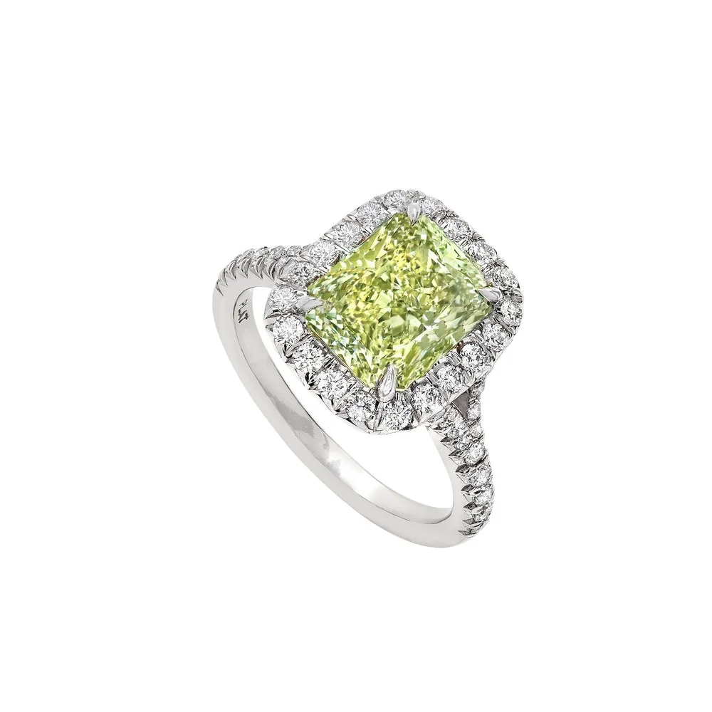 3.24 carat Fancy Intense Yellowish Green Diamond Halo with mini split shank Ring. Surrounding the center stone are 0.66 carats of Round Brilliant Cut Diamonds. Set in platinum.