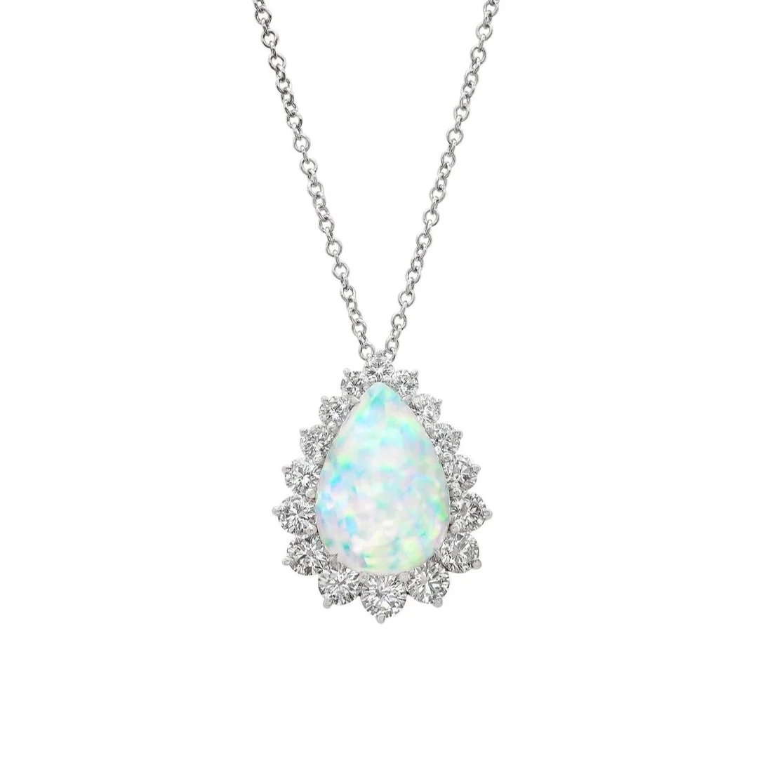 7.18 carat Pear shaped Opal Pendant. 2.56 carats of Round Brilliant Cut Diamonds surround the center stone. 9.74 carat total weight. Set in 18k white gold.