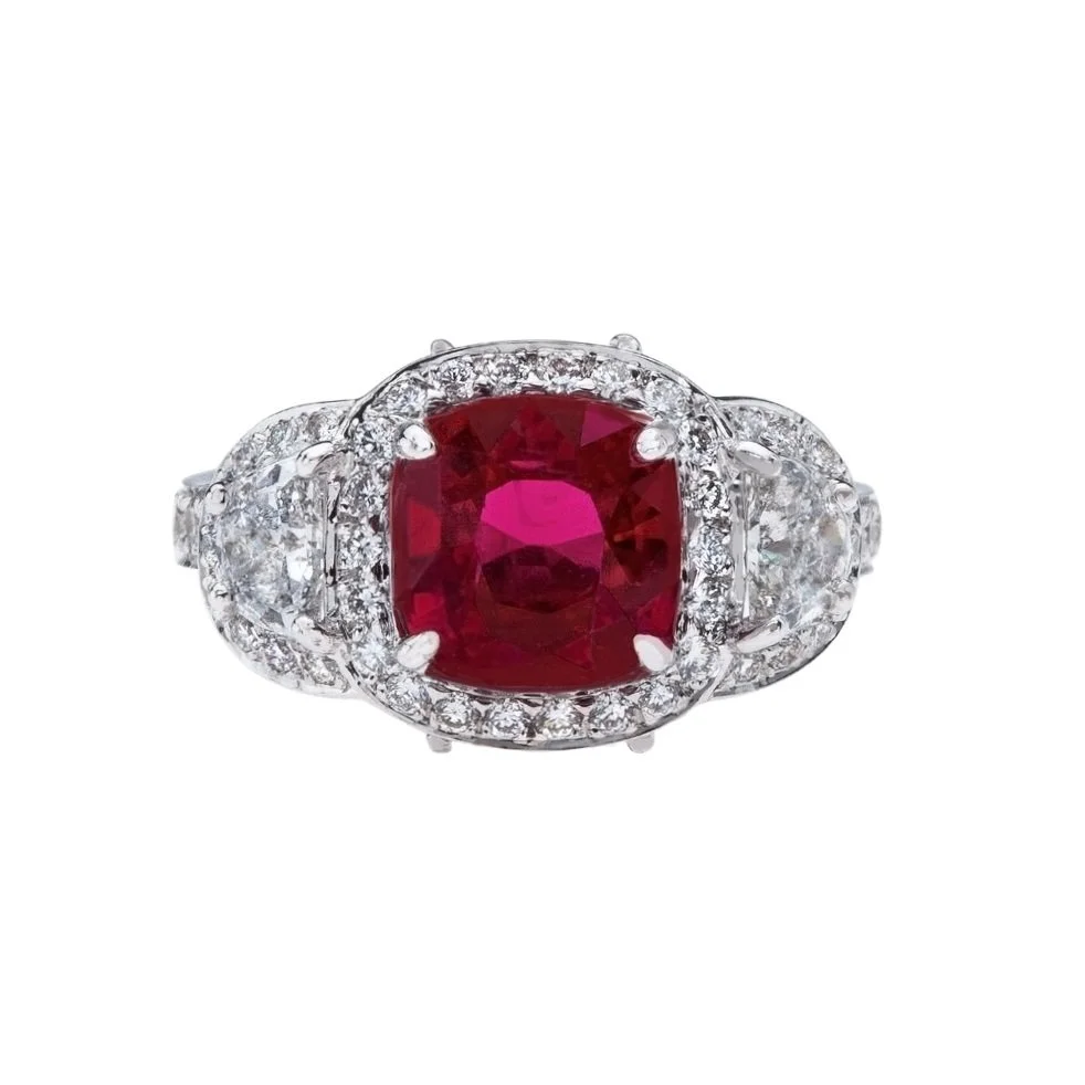 2.86 carat Cushion Cut Ruby Ring with Butterfly Diamond details. Surrounding the center stone are Half-Moon Cut Diamonds, Marquise Cut Diamonds and Round Brilliant Cut Diamonds.