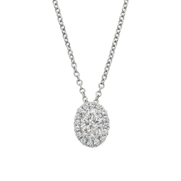 1.05 carat Oval Cut Halo Diamond Pendant. 0.22 carats of Round Brilliant Cut Diamonds surround the center stone. Set in 18k white gold.