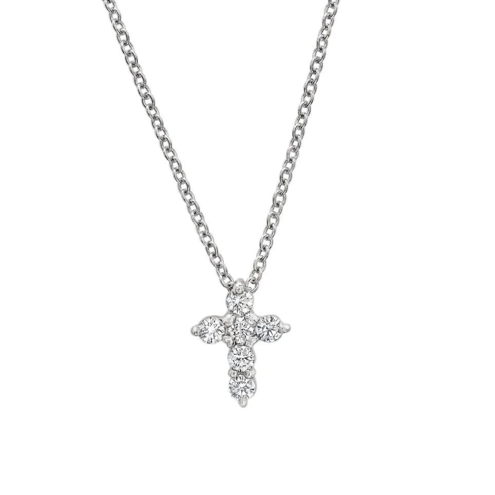 Signature Mini Cross; 0.15 carats of Round Brilliant Cut Diamonds. Set in 18k white gold. 