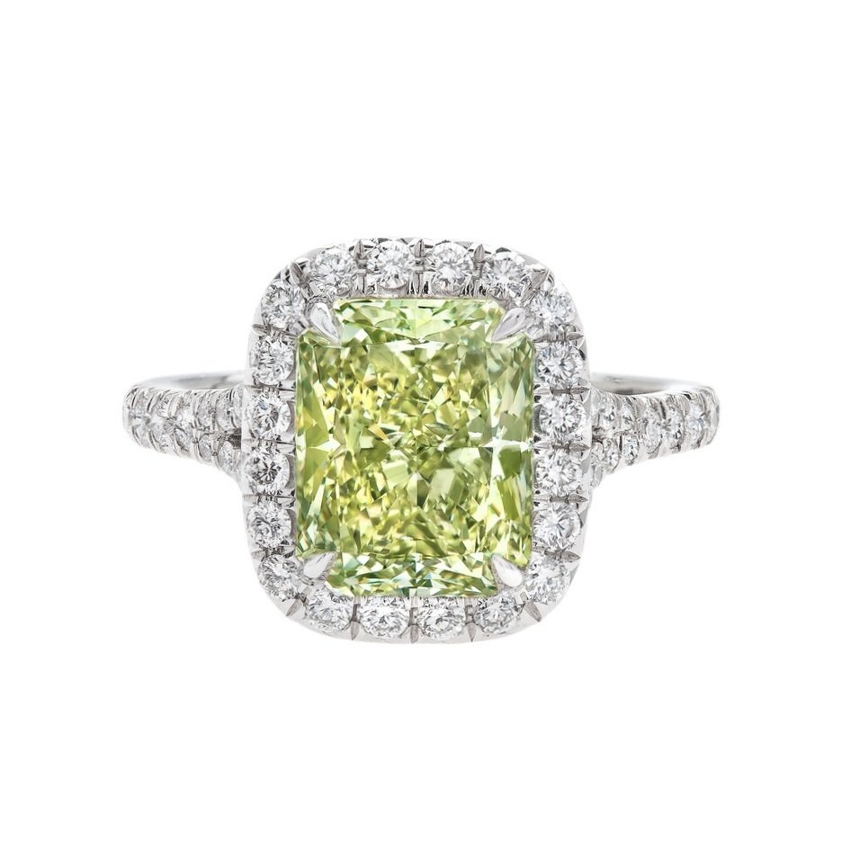 3.24 carat Fancy Intense Yellowish Green Diamond Halo with mini split shank Ring. Surrounding the center stone are 0.66 carats of Round Brilliant Cut Diamonds. Set in platinum.