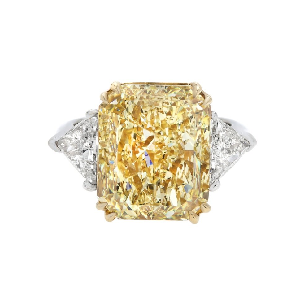 12.72 carat Fancy Yellow Radiant Cut Diamond 3 stone Ring. Two Trillion Cut Diamonds surround the center stone. Set in 18k yellow gold and platinum. 
