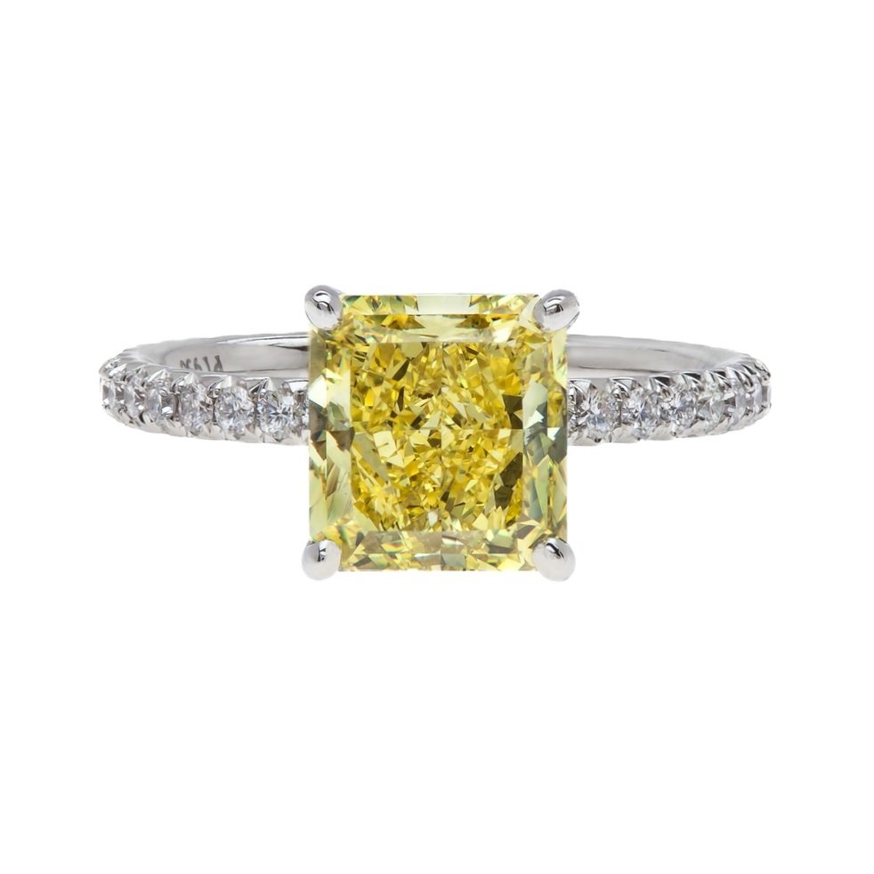 3.01 carat Radiant Cut Fancy Intense Yellow Diamond Ring. Diamonds are on the band. Set in platinum.