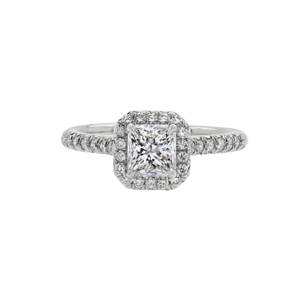 1.01 carat Radiant Cut Diamond Halo Ring with diamonds on the band; 1.41 carat total weight. Set in platinum. 
