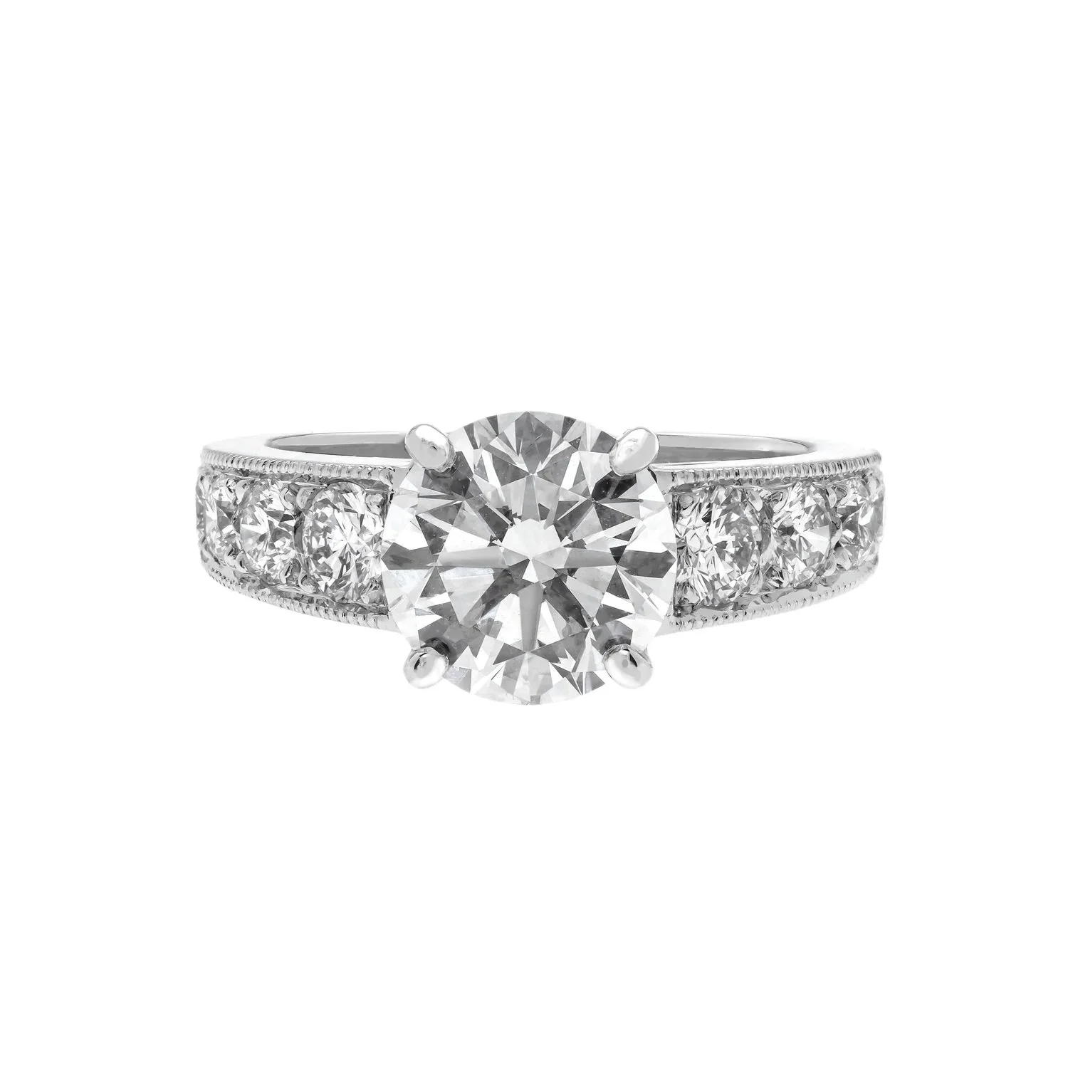 Custom made 2.71 carat round brilliant cut diamond solitiare ring with 0.91 carats of tapered round diamonds on the band with light milgrain detail set in platinum