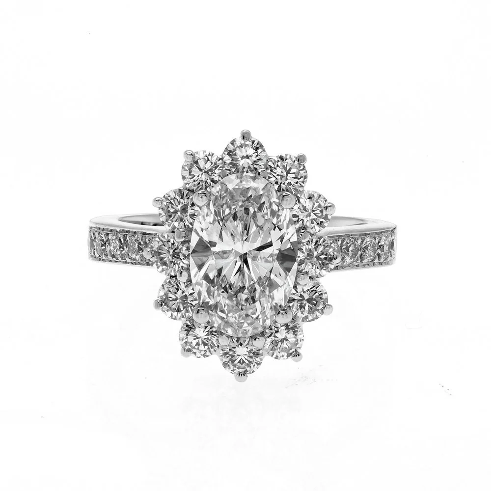 2.13 carat Oval Cut Diamond Halo Ring; 3.34 carat total weight. Set in platinum.