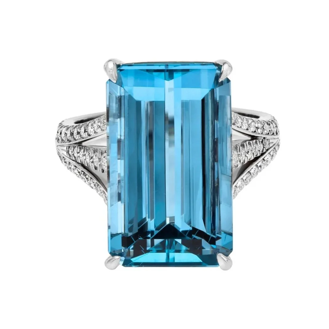 Antique Fashion 11.27 carat Emerald Cut Aqua Ring. Going down the triple shank are 0.58 carats of Round Brilliant Cut Diamonds. Set in 18k white gold.