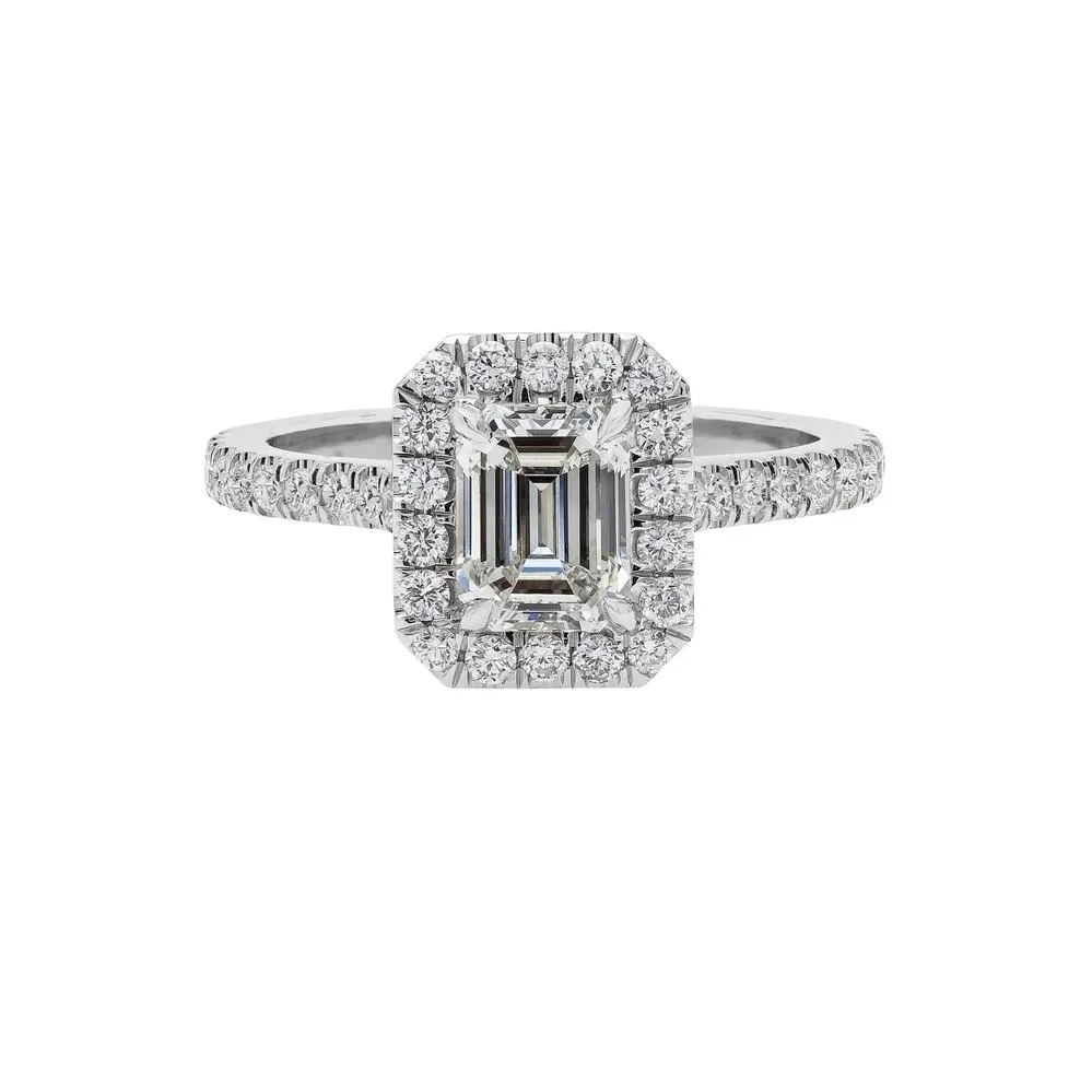 1.15 carat Emerald Cut Diamond Halo Ring; 1.69 carat total weight. Set in platinum.