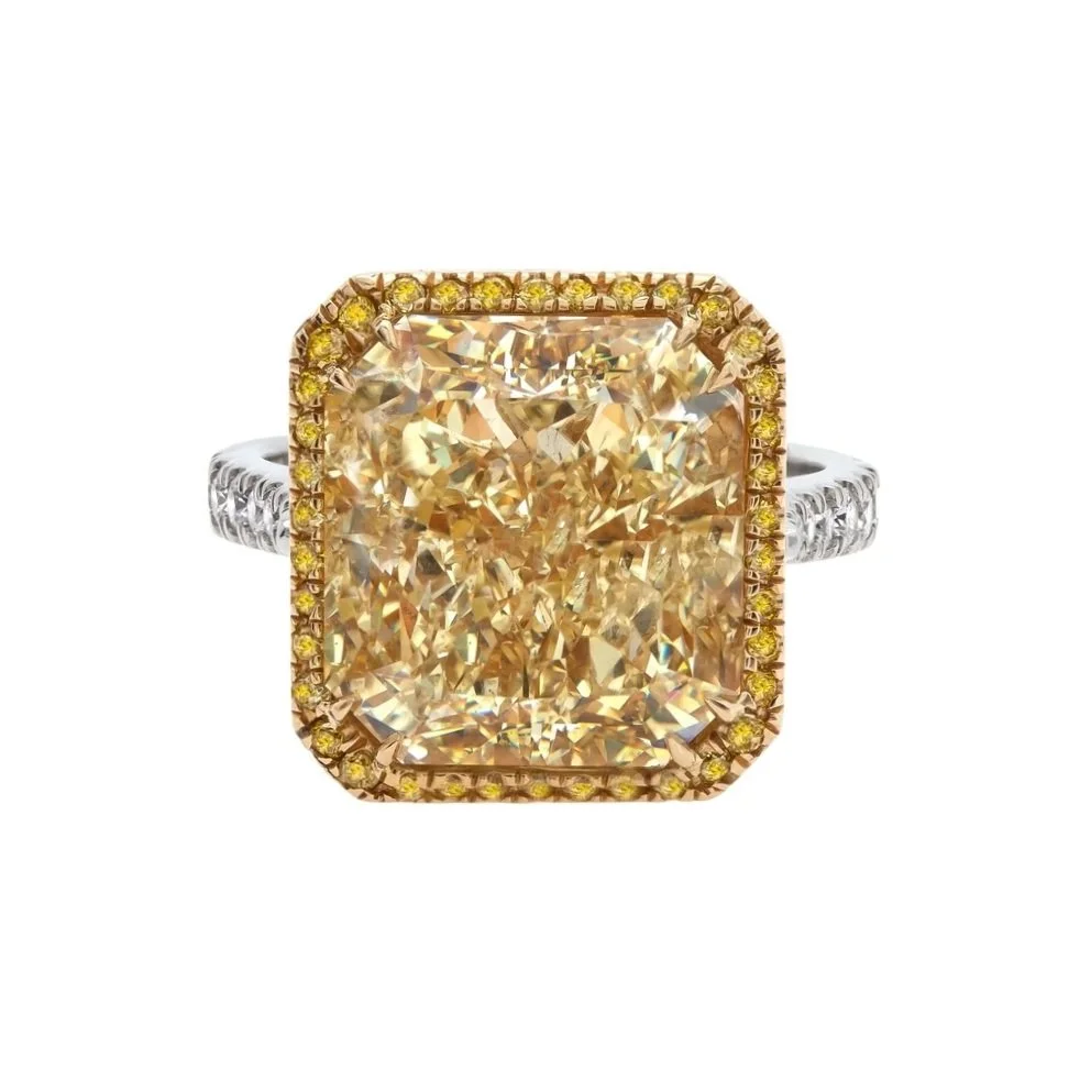 11.71 carat Radiant Cut Fancy Yellow Diamond Halo Ring. Fancy Intense Yellow Diamonds in halo and 1.03 carats of Round Brilliant Cut Diamonds on band. Set in Platinum and 18k yellow gold. 