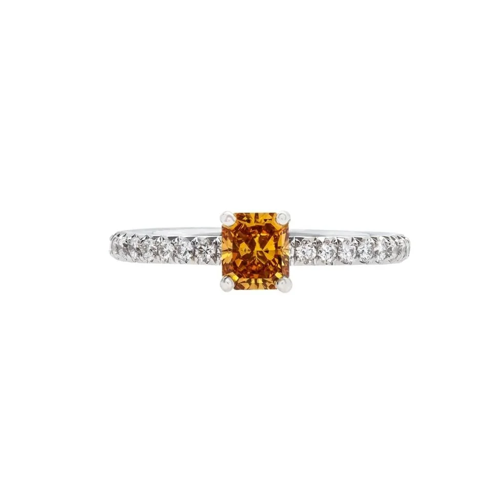 0.63 carat Round Fancy Deep Yellow/Orange Diamond Ring. 0.46 carats of Round Brilliant Cut Diamonds on the band. 1.09 carat total weight. Set in platinum.