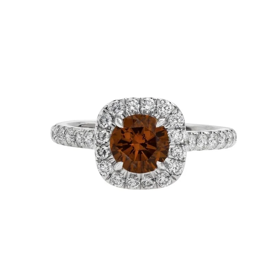 1.02 carat Fancy Cognac Round Diamond Cushion Halo Ring. Surrounding the center stone are 0.64 carats of Round Brilliant Cut Diamonds in the Halo and on the band. Set in platinum.