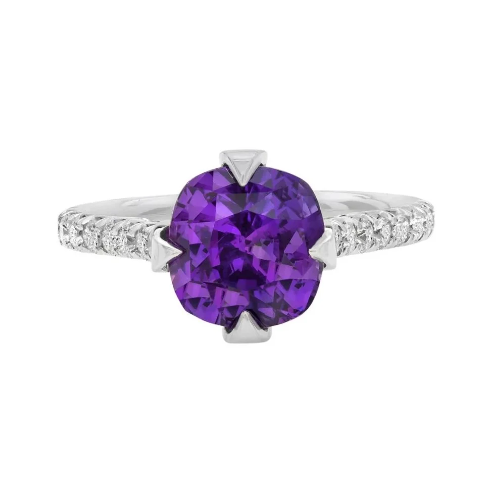 4.58 carat Cushion Cut Purple Sapphire Ring. 0.60 carats of Round Brilliant Cut Diamonds surround the center stone. Set in platinum. 