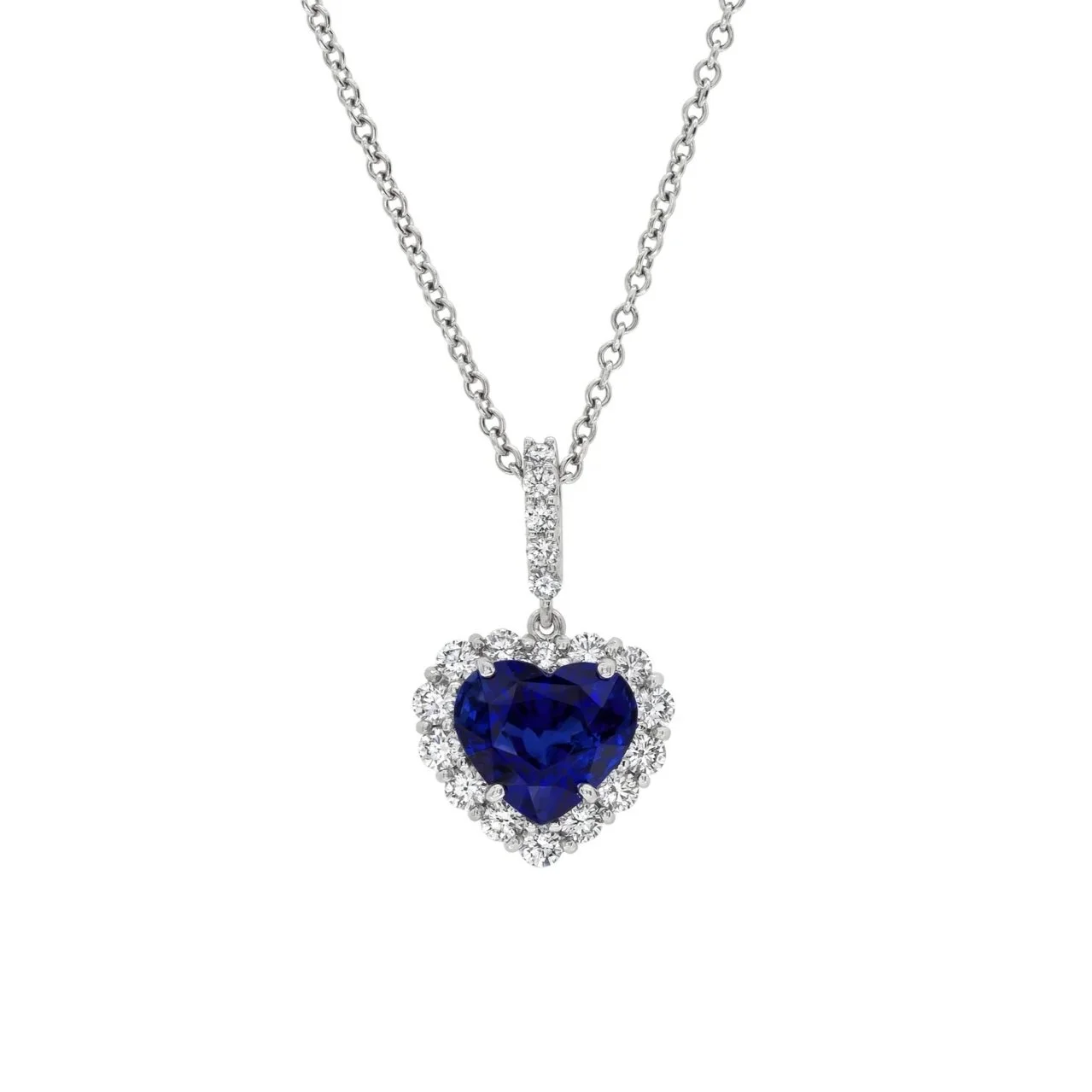 4.48 carat Sapphire Heart Pendant. 0.86 carats of Round Brilliant Cut Diamonds surround the center stone. Set in platinum.