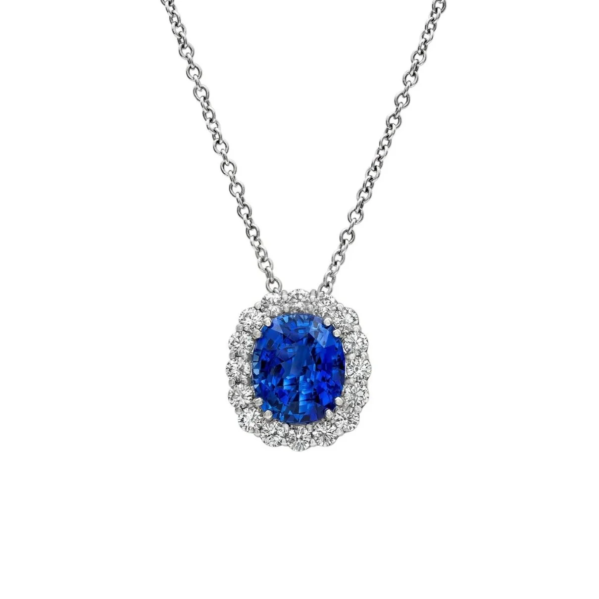 5.00 carat Cushion Cut Sapphire Pendant. 0.82 carats of Round Brilliant Cut Diamonds surround the center stone. Set in 18k white gold. 