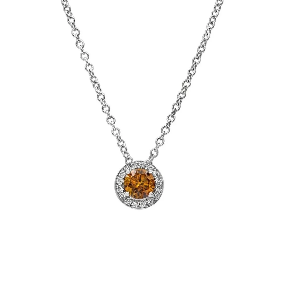 0.57 carat Round Fancy Deep Brownish Orangy Yellow&nbsp;Diamond Pendant. 0.12&nbsp;carats of Round Brilliant Cut Diamonds surround the center stone. Set in 18k white gold.&nbsp;