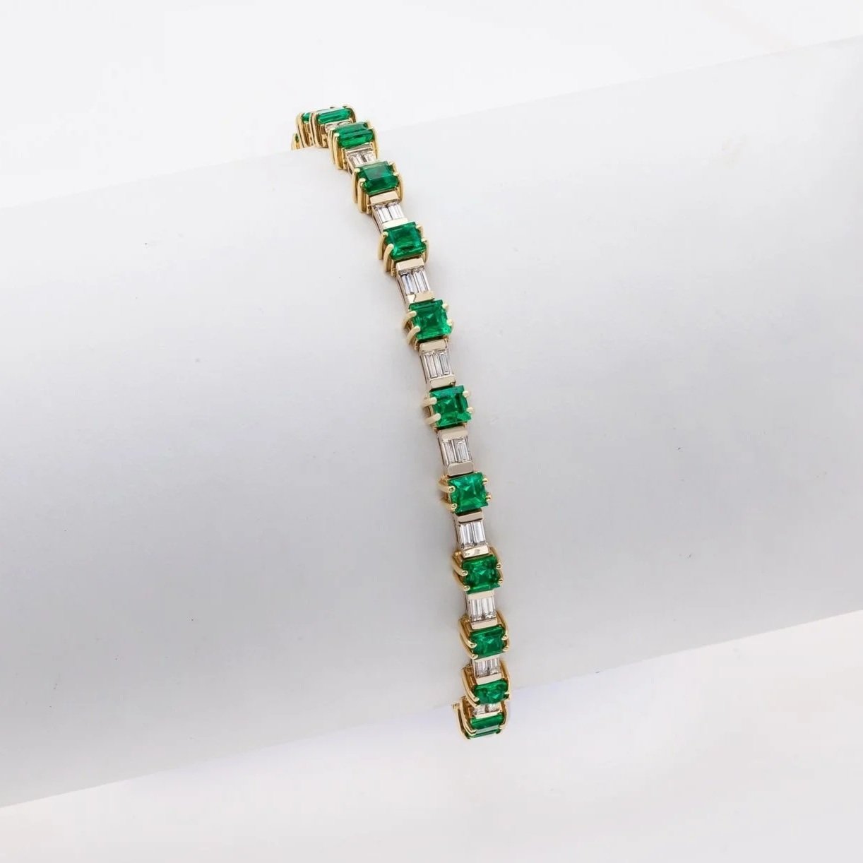 Emerald and Diamond Bracelet; 5.06 carats of Emeralds and 1.75 carats of Baguette Cut Diamonds. Set in 18k white and yellow gold.