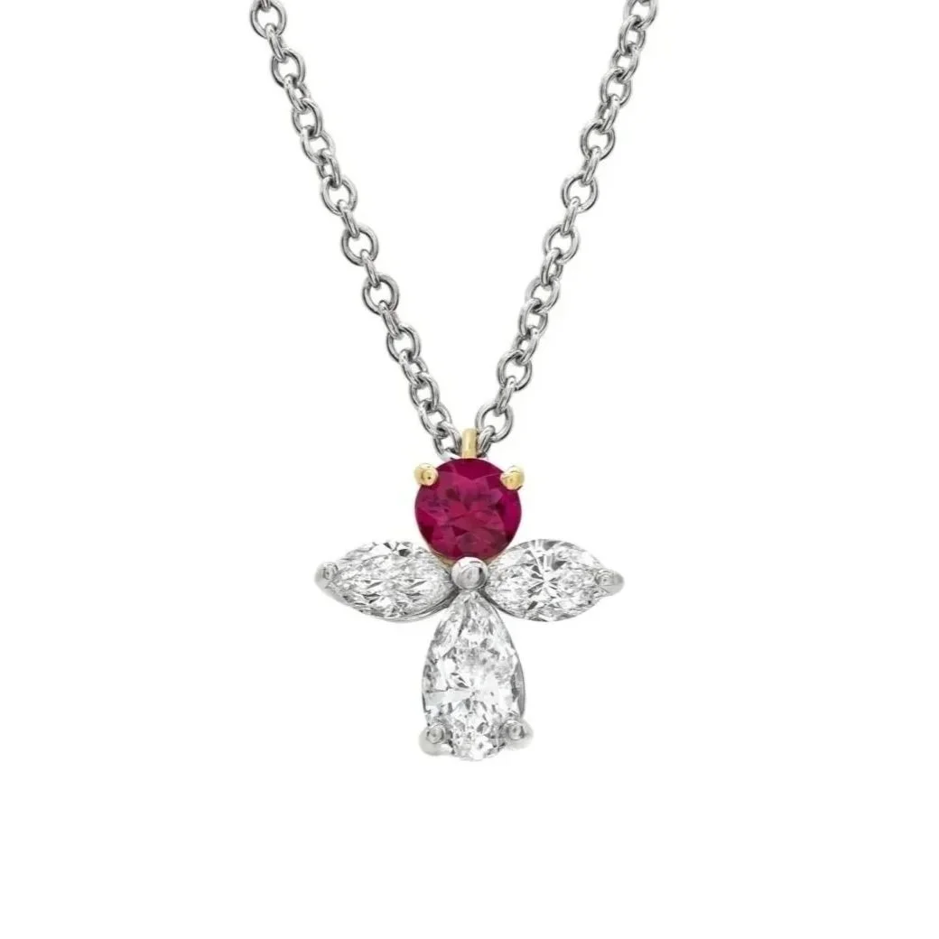 Ruby Angel Pendant; featuring one 0.34 carat Round Ruby and 0.89 carats of Marquise Cut and Pear Cut Diamonds. Set in 18k white and yellow gold.