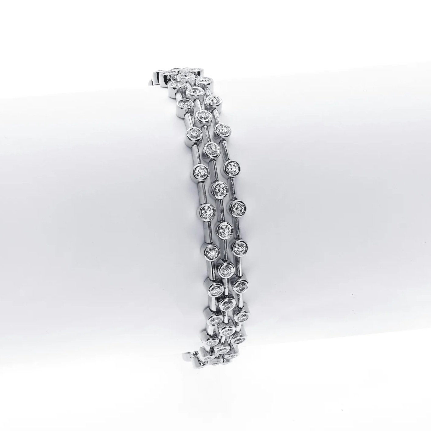 Triple Row Bracelet with 5.18 carat total weight in Round Brilliant Cut Diamonds. Set in 18k white gold.
