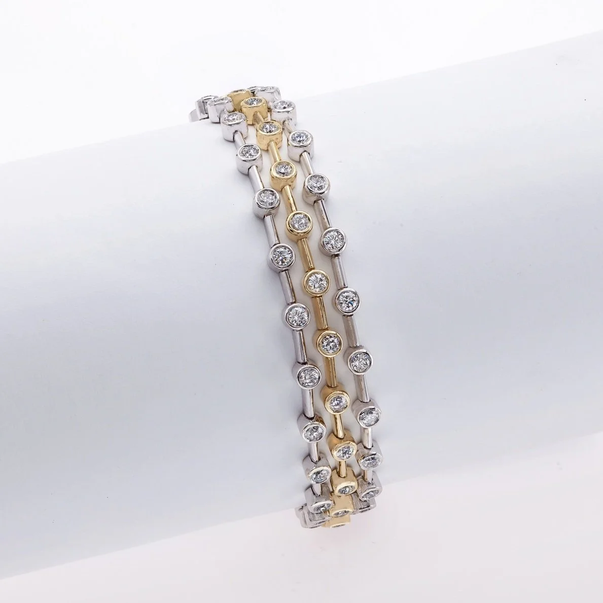 Triple Row Bracelet with 5.76 carat total weight in Round Brilliant Cut Diamonds. Set in 18k white and yellow gold. 