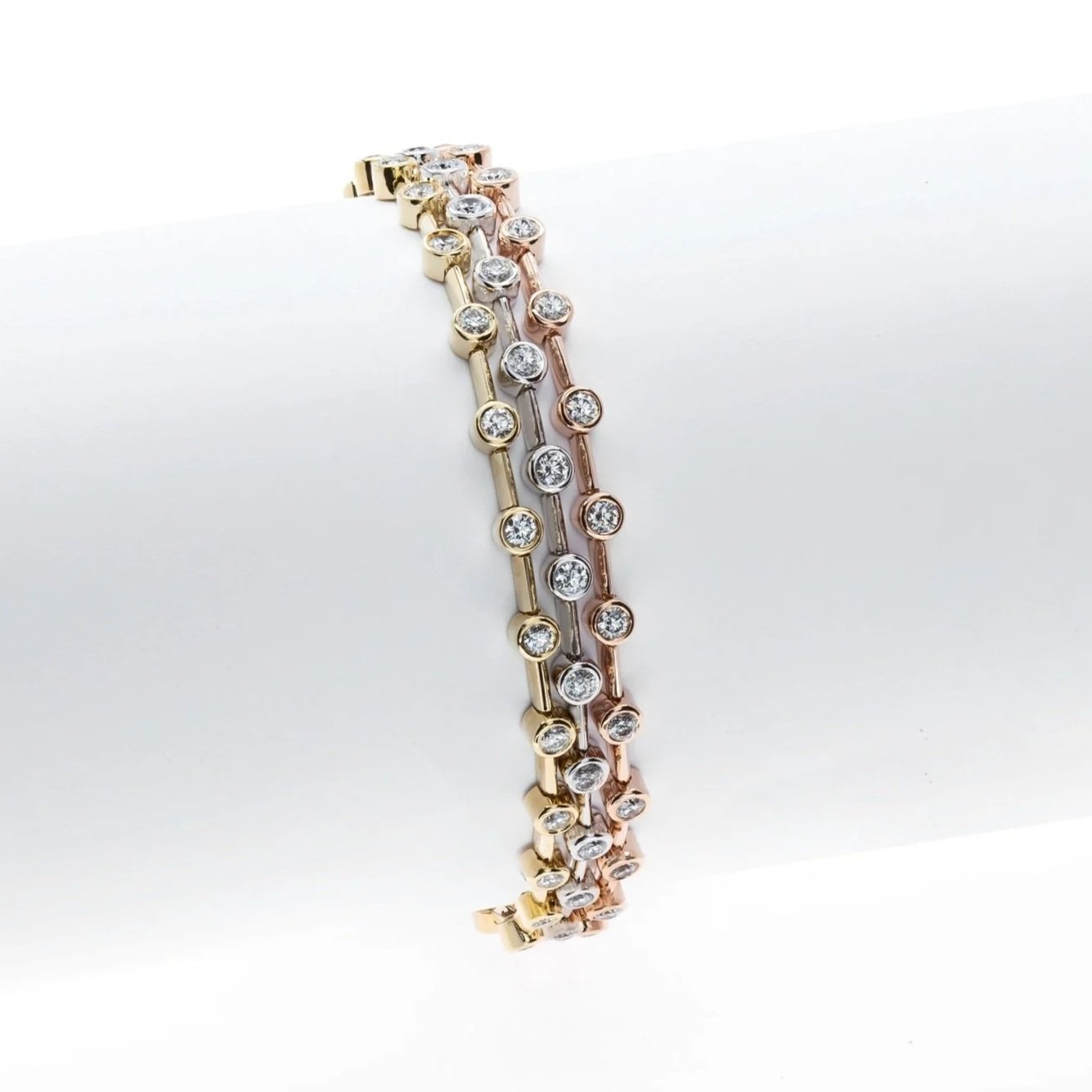 Triple Row Bracelet with 5.14 carat total weight in Round Brilliant Cut Diamonds. Set in 3 shades of gold; 18k yellow gold, 18k white gold, and 18k rose gold.