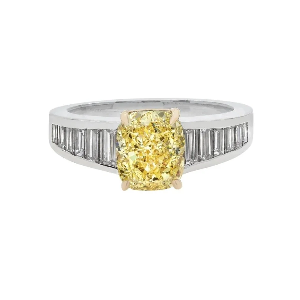 2.53 carat Fancy Intense Yellow Radiant Cut Diamond Ring. Baguette Diamonds are tapered down the sides. Set in platinum.