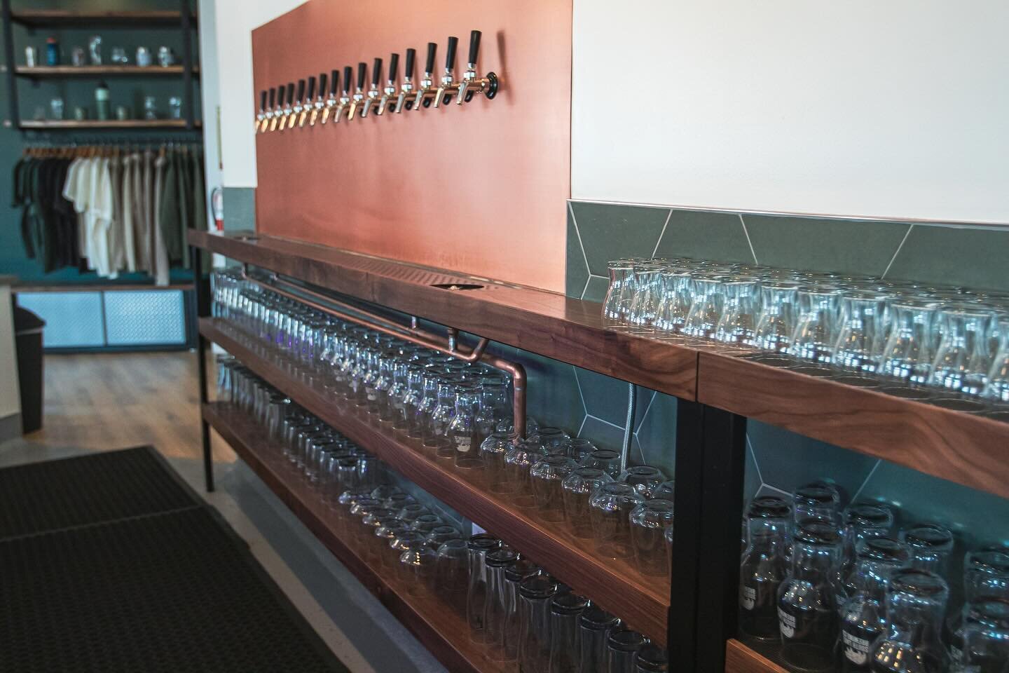 Last year, we built a custom 20&rsquo; bar shelf for @southlakebrewco&rsquo;s new location, complete with a cutout for an integrated drain, low/high walnut &amp; steel tables, mitered hanging wall tables (not pictured), and a 3-way corner countertop 