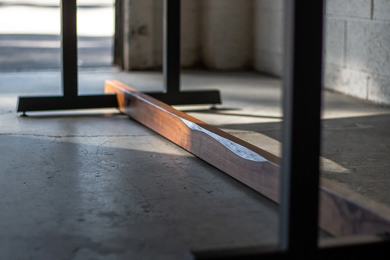 &lsquo;Emblem&rsquo; dining table in Bastogne Walnut and steel