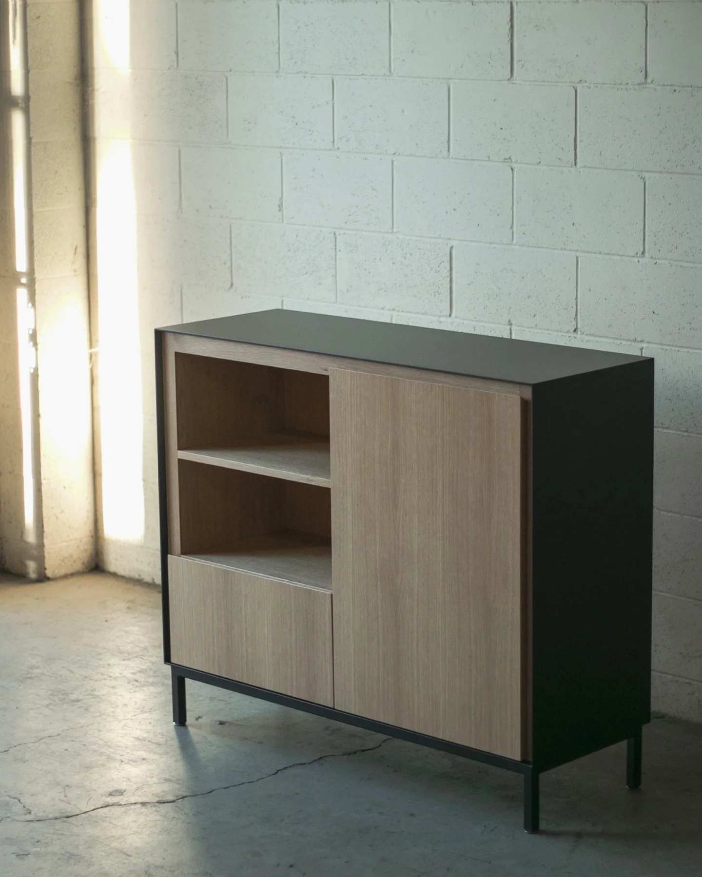 Off The Wall Sideboard. Plate steel case with a white oak interior, flowing grain fronts and a mix of open and adjustable shelving.

Made to pair with a dining table we built years back, at home in Chicago.

#customcabinetry #woodwork #furnituredesig