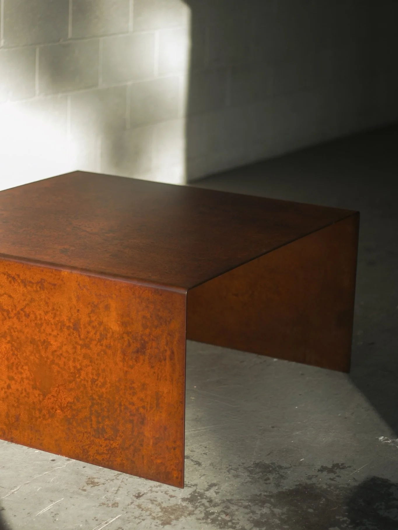 A closer look at the finished piece and process of this HRPO brake formed coffee table. Sculpt Nouveau&rsquo;s Japanese Brown patina on hot rolled pickled and oiled plate. Brake formed, sanded, patinated, neutralized, and clear powdercoated.

Our met