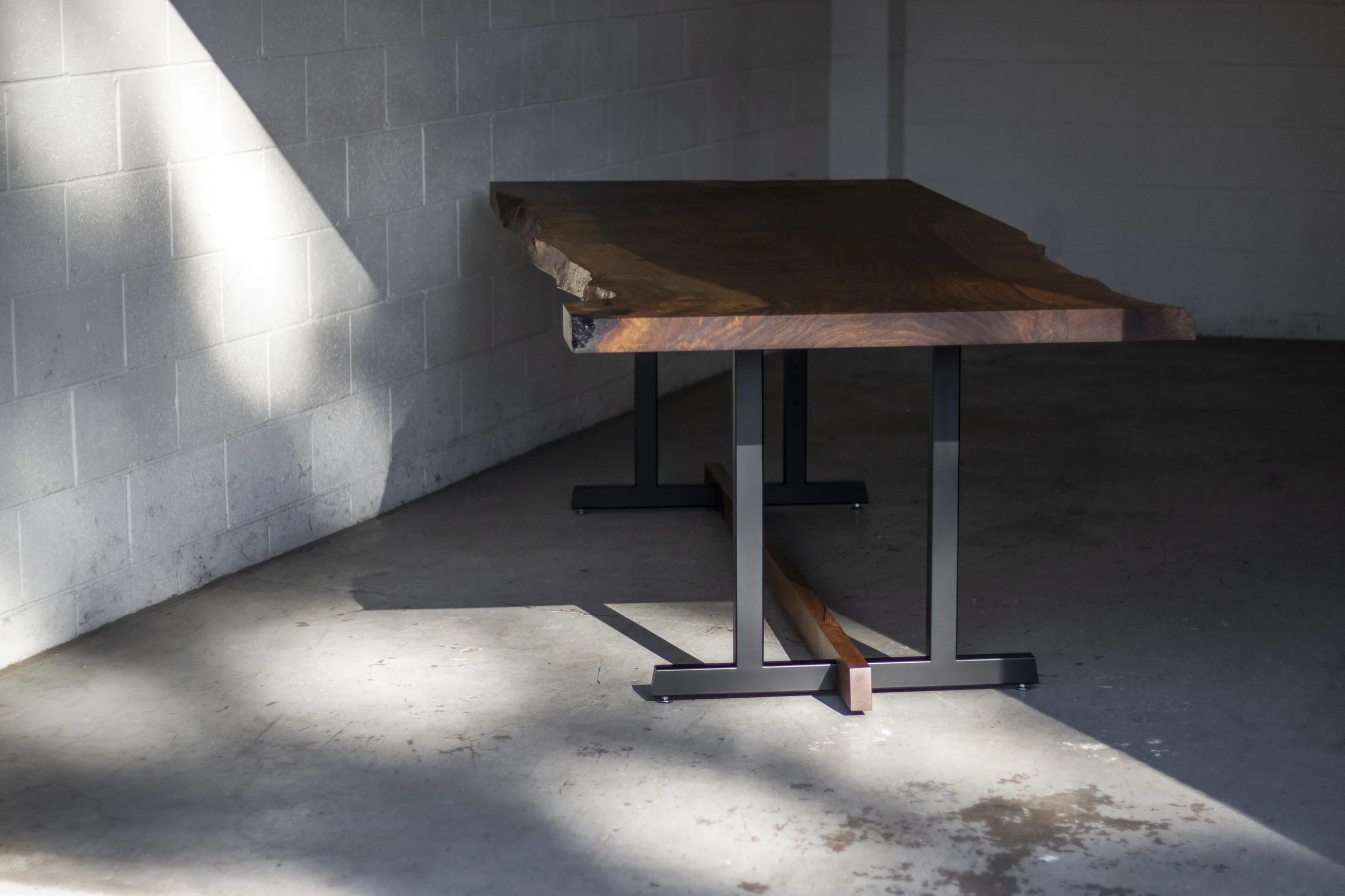 EMBLEM  |  Live Edge Walnut Slab Dining Table  |  Steel Trestle Base w/ Wood Stretcher Accent