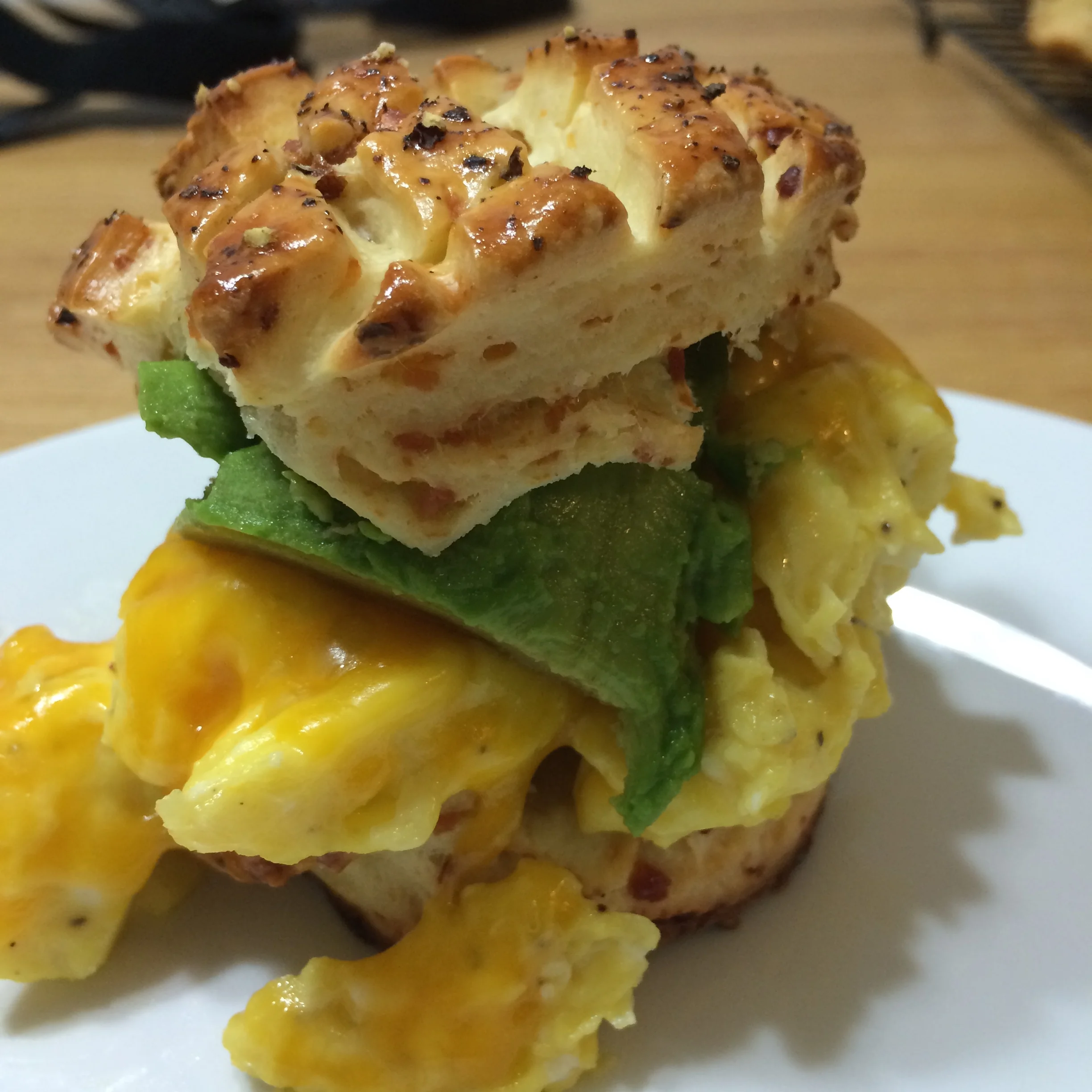 avocado, egg and cheese on pogacsa