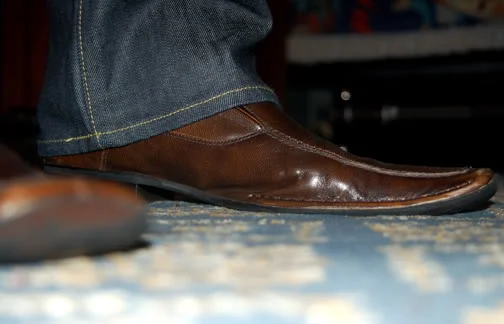 the colors are a good match but the opening of the jeans are too wide for such a sleek pair of slip on leather shoe