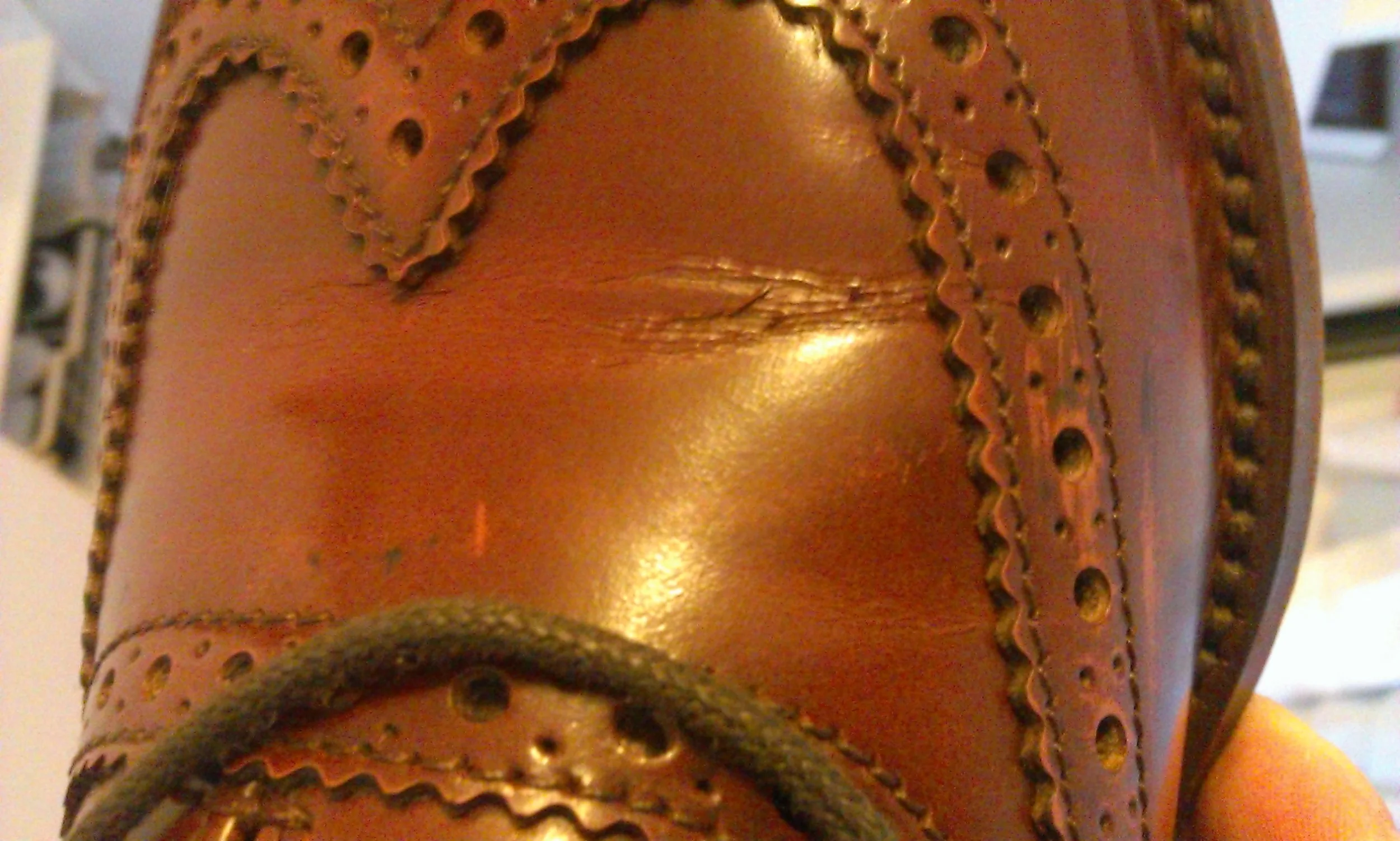 Corrected grain leather usually show cracks on the surface of the leather rather than gentle creases. 