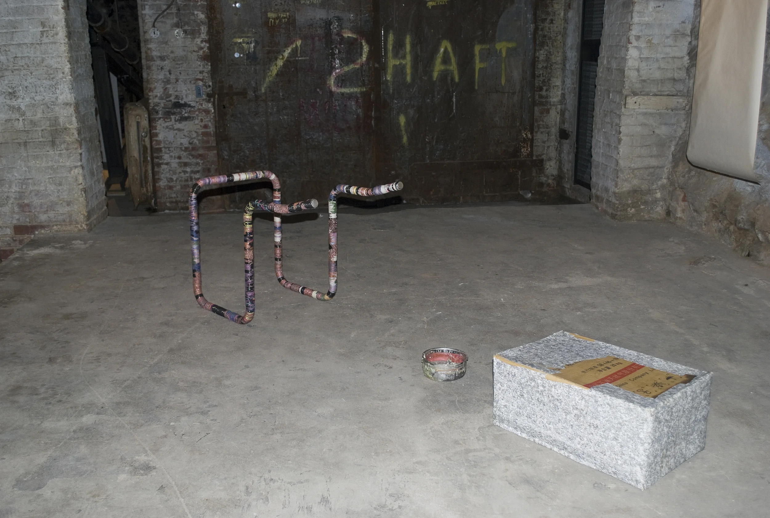 PW3 "Cobra Gimp", 2011, metal, string, and "Museum piece with fountain", 2011, wax, popcorn, cardboard, paper, metal bowl, dimensions variable