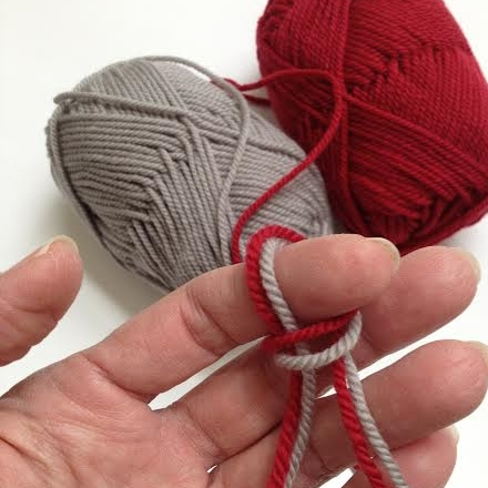 Leaving approximately 5" tails, make a *slipknot with both strands of yarn. * Slipknot with both strands are dropped when the cast-on is completed.