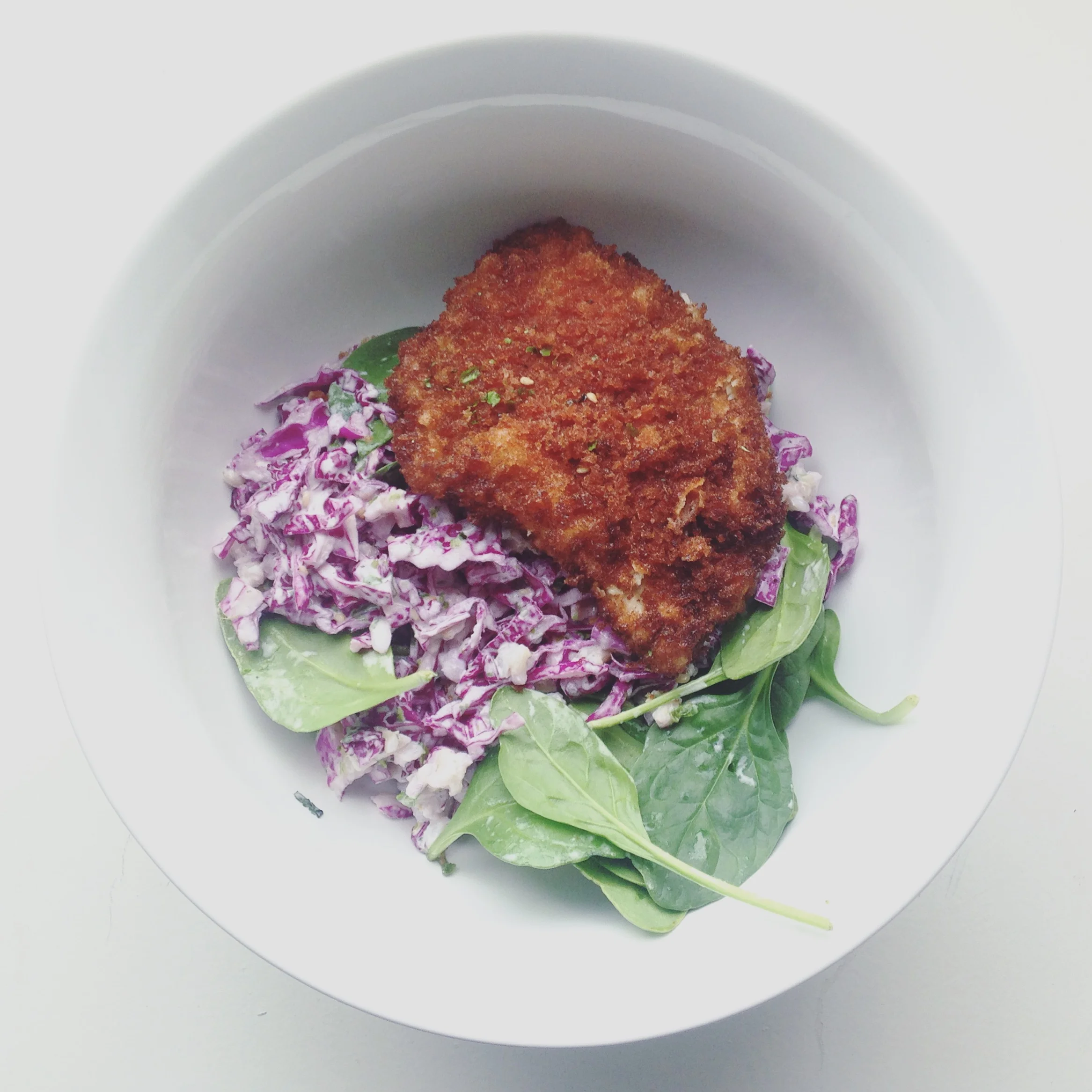  Pork Tonkatsu over red cabbage and spinach salad. 