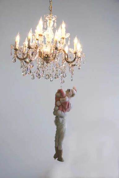 April Childers, Its Almost Friday (Hang On Kitty) , 2009. Chandelier, lights, taxidermied cat, motor, kitty clothing. Dimensions variable.