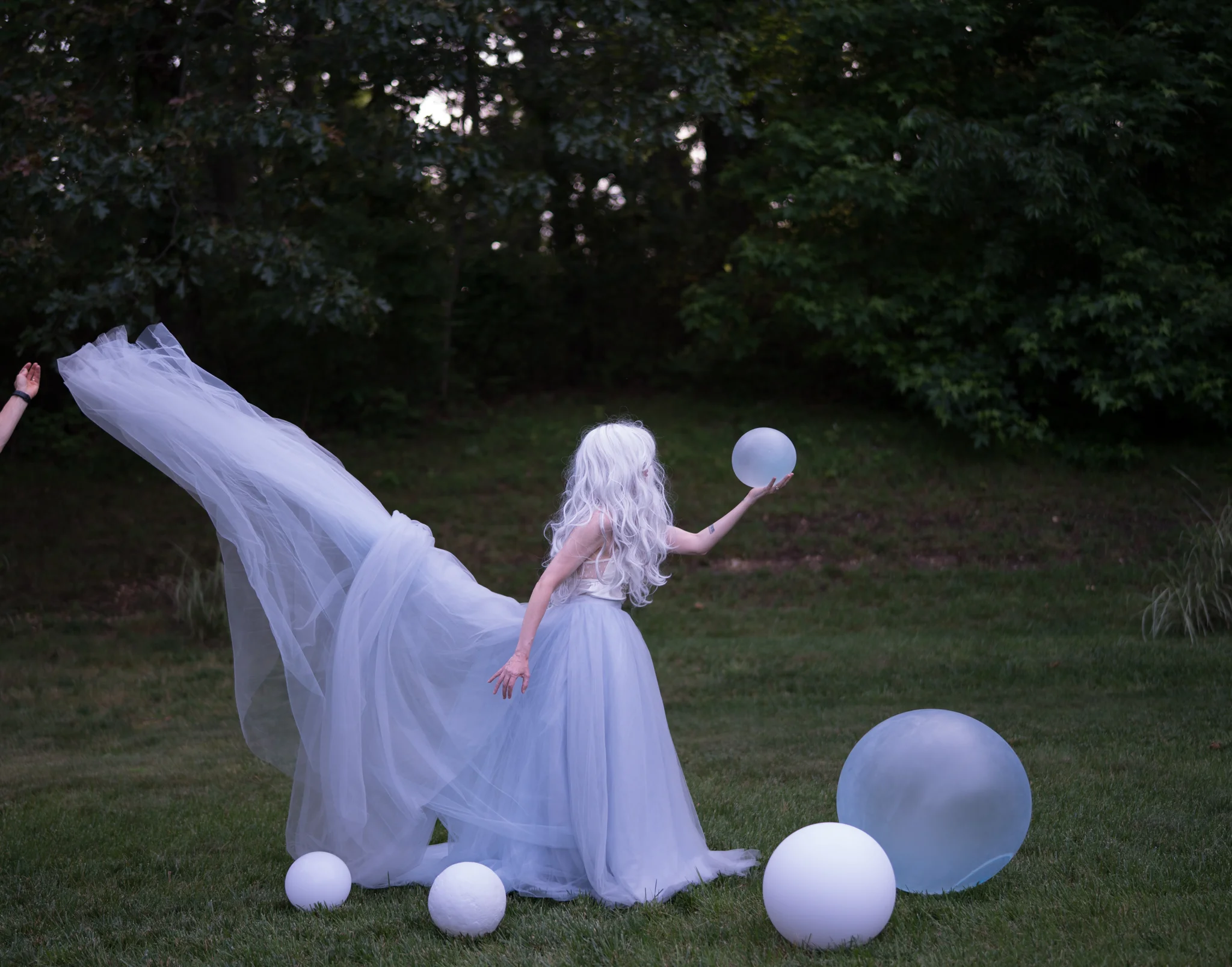 You can see the hand on the left by the dress.
