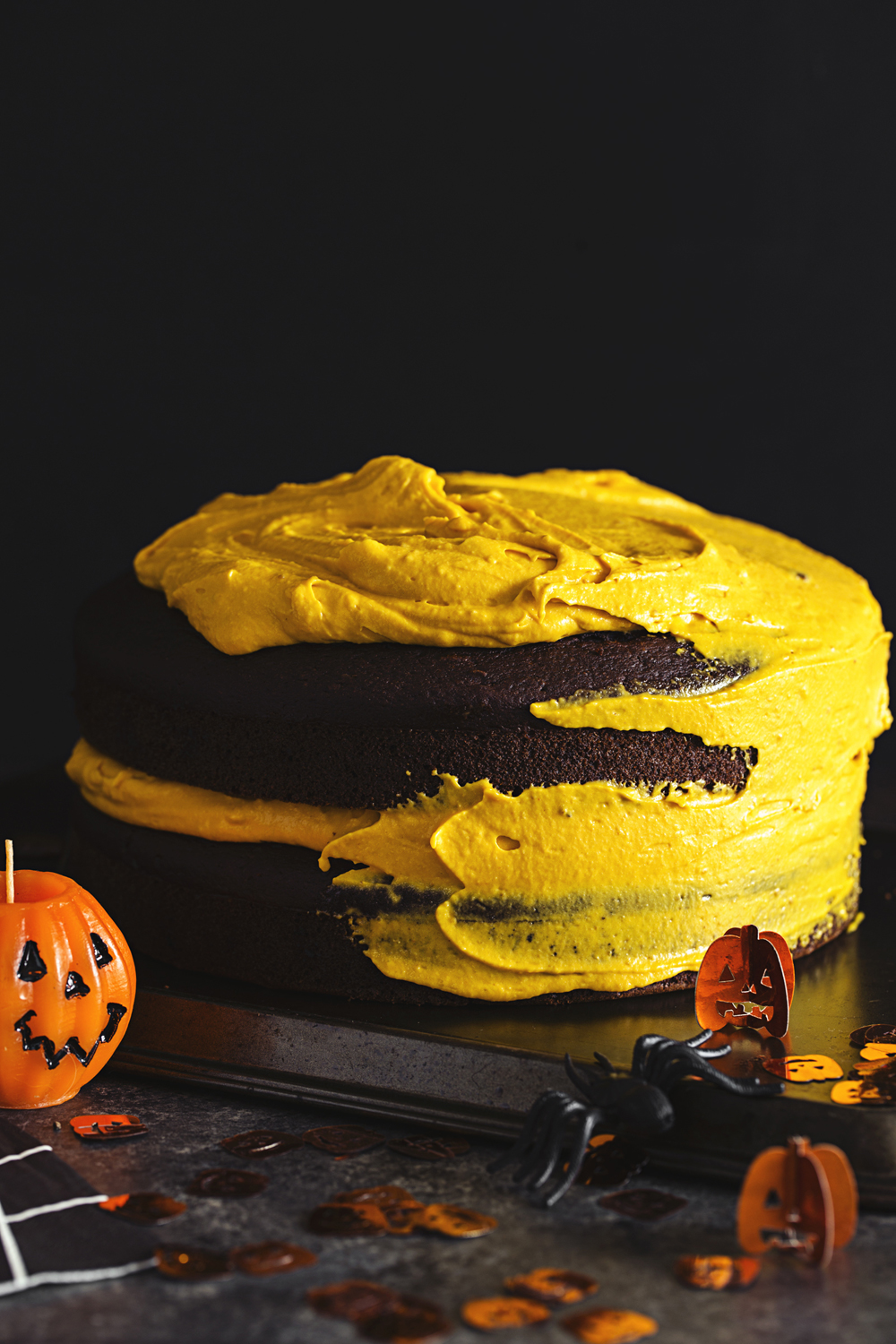 Vegan Halloween Recipe: deliciously fluffy and moist Chocolate &amp; Pumpkin Cake, frosted with an Orange Cashew “Buttercream”.