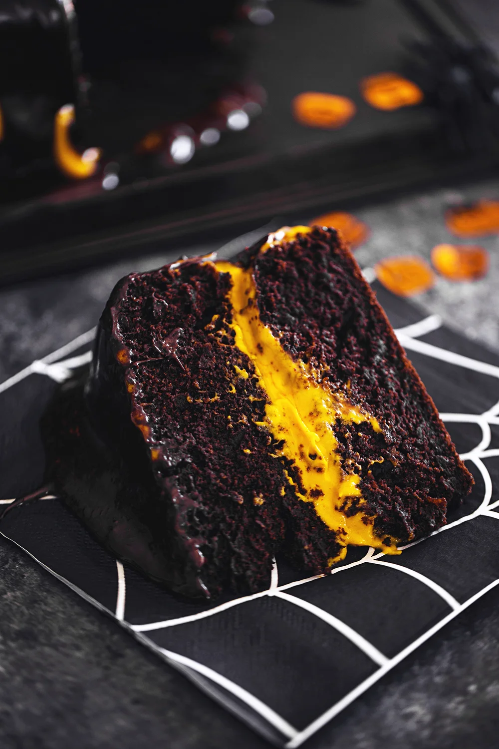 Vegan Halloween Recipe: deliciously fluffy and moist Chocolate &amp; Pumpkin Cake, frosted with an Orange Cashew “Buttercream”.