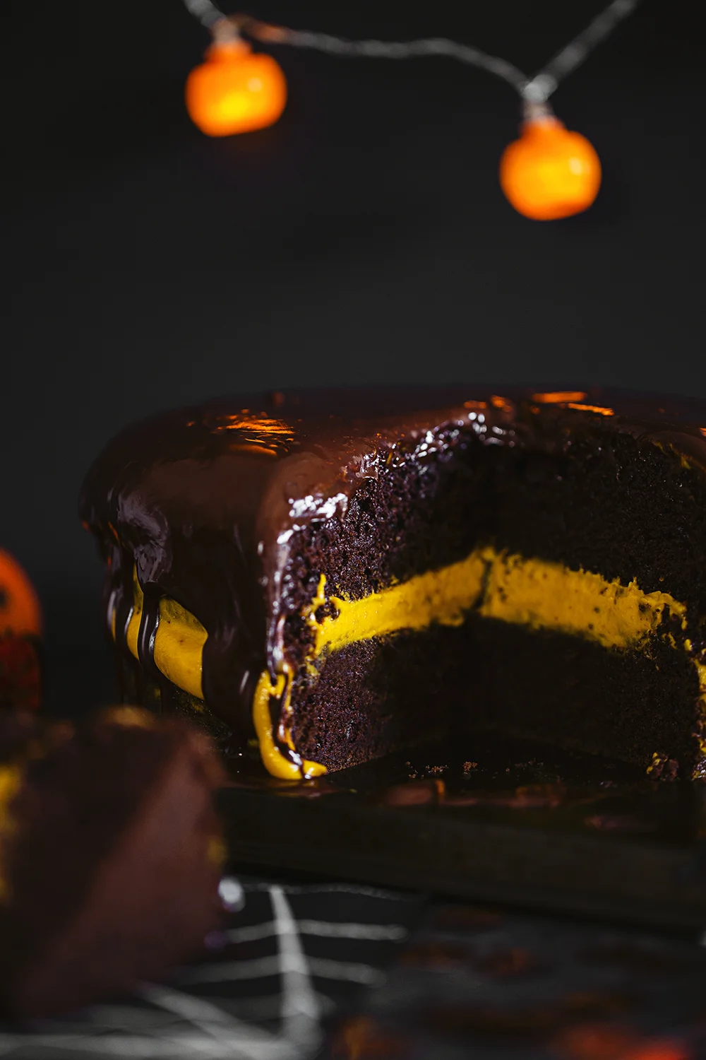 Vegan Halloween Recipe: deliciously fluffy and moist Chocolate &amp; Pumpkin Cake, frosted with an Orange Cashew “Buttercream”.