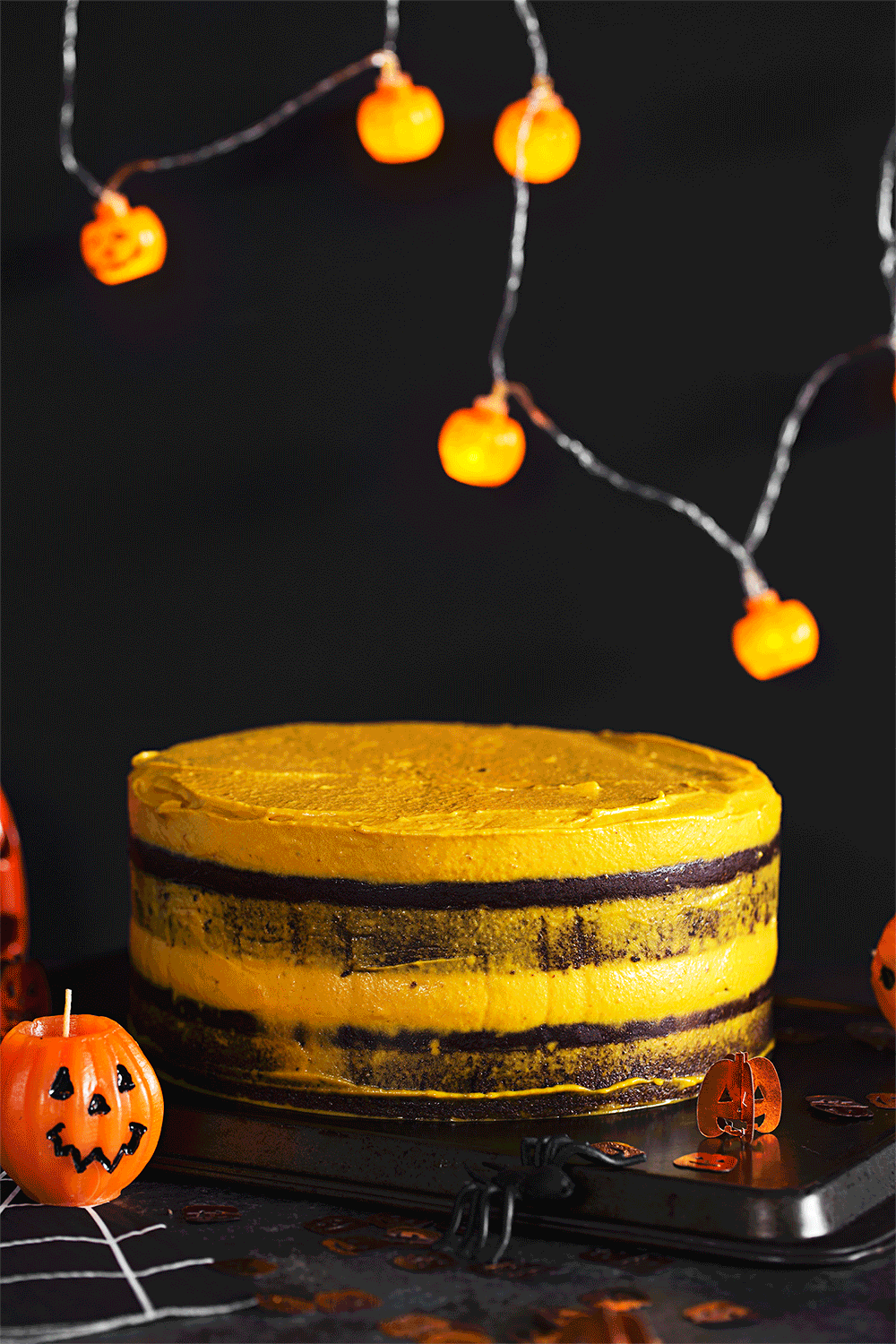 Vegan Halloween Recipe: deliciously fluffy and moist Chocolate &amp; Pumpkin Cake, frosted with an Orange Cashew “Buttercream”.